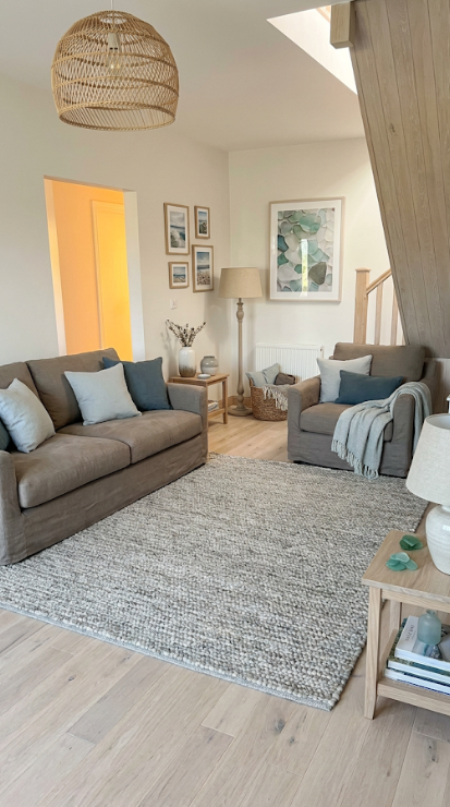 The same living room restyled in a layered coastal palette